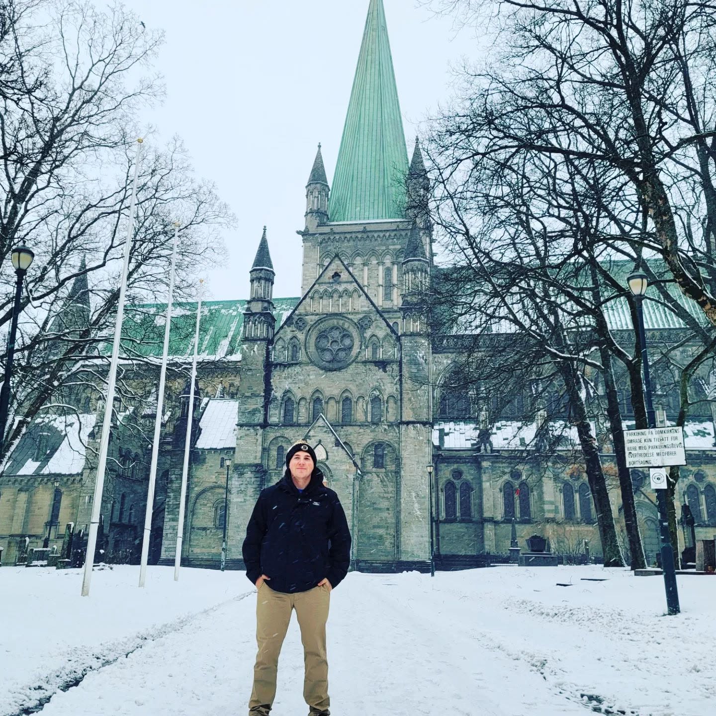 Devyn Harrington standing in front of Nidaros Cathedral in snowy Trondheim, Norway