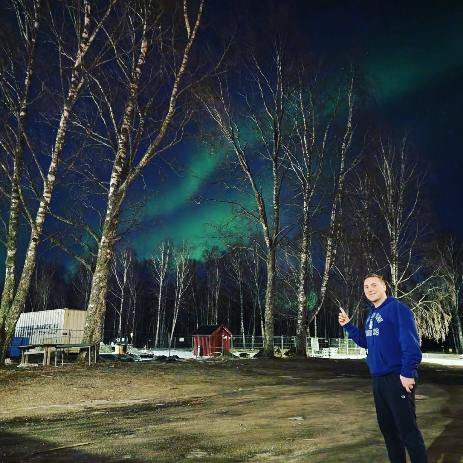 Devyn Harrington standing beneath the Northern Lights during the Norway deployment