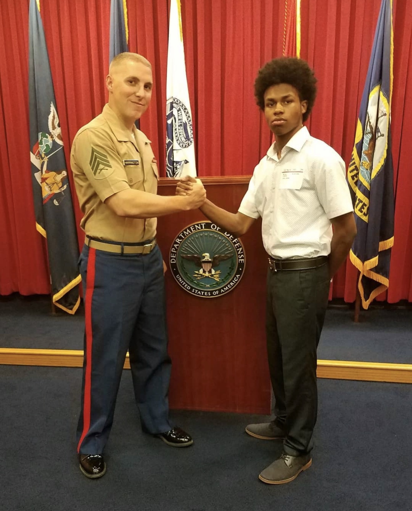 Devyn Harrington welcoming Albany High School student Javon Capio into the Marine Corps Delayed Entry Program