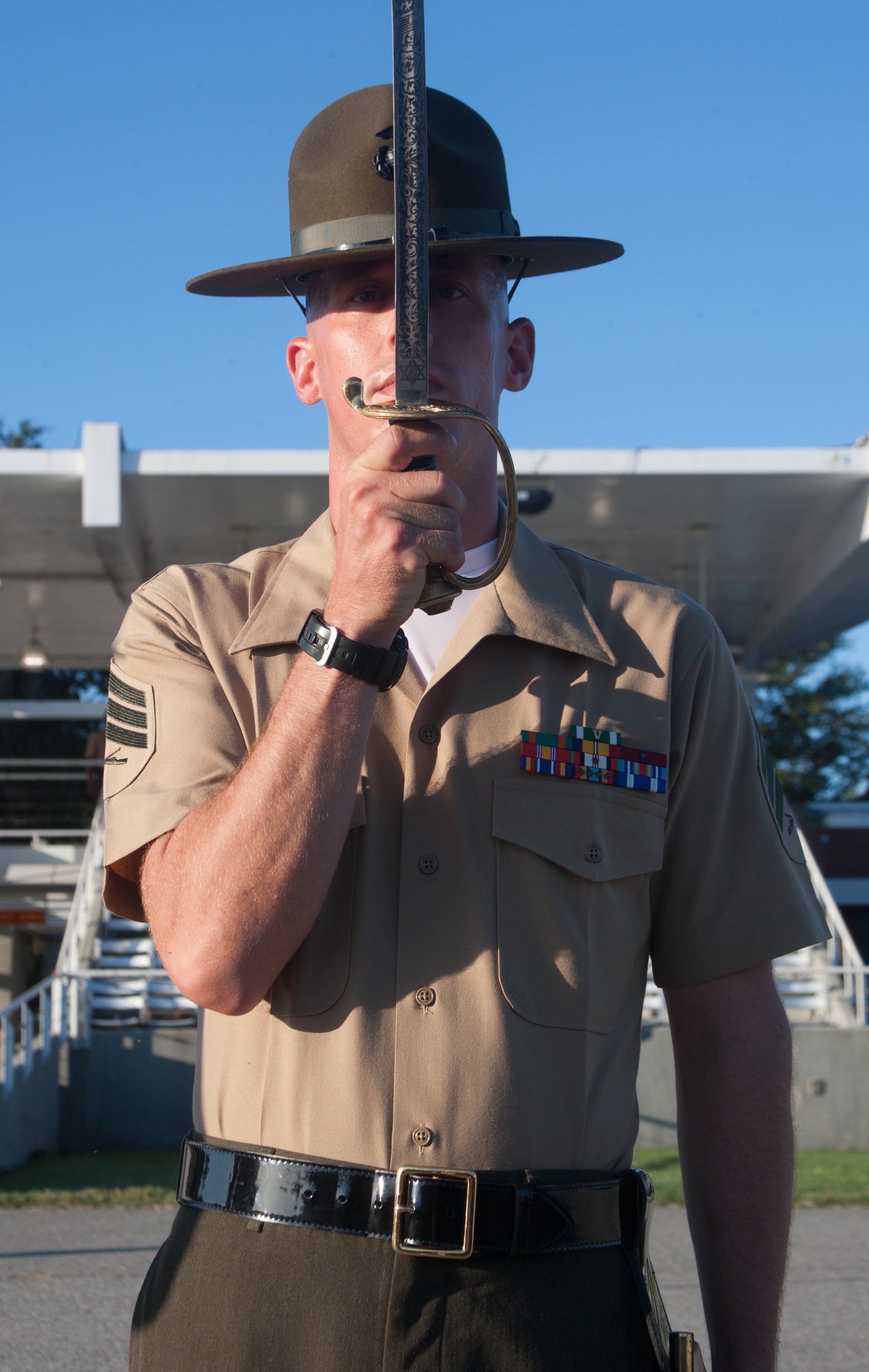 Sgt. Matthew Anderson, senior drill instructor for Golf Company, Platoon 2064, saluting with his noncommissioned officer's sword during final drill