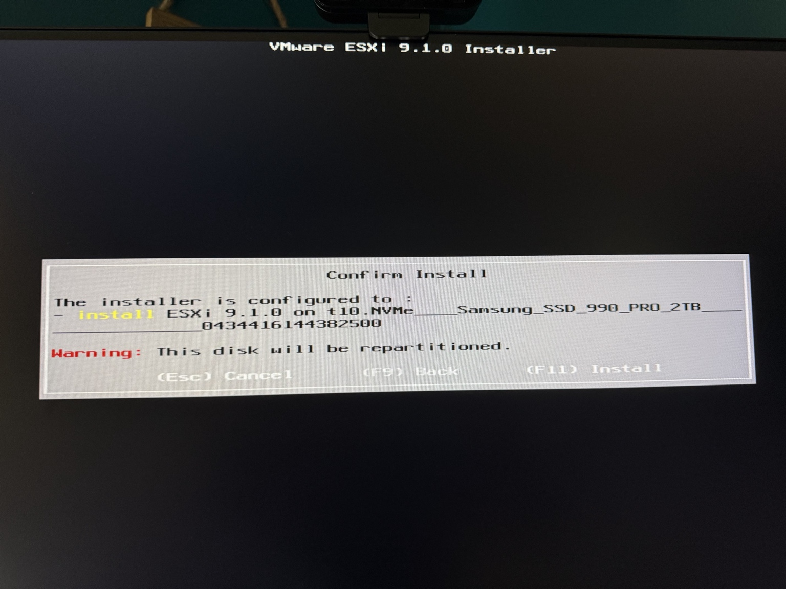 VMware ESXi 9.1 installer confirmation warning that the selected Samsung 990 PRO 2 TB disk will be repartitioned